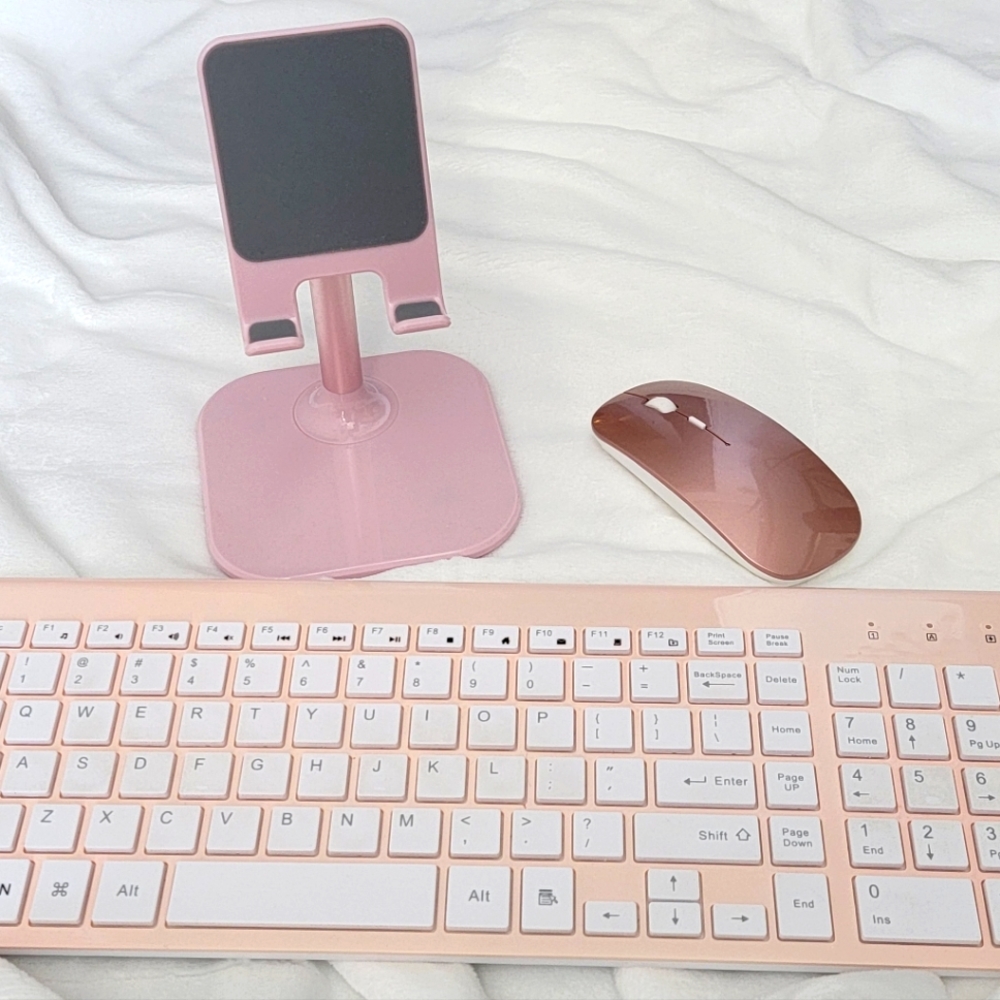 Pink wireless keyboard, mouse and ohone stand